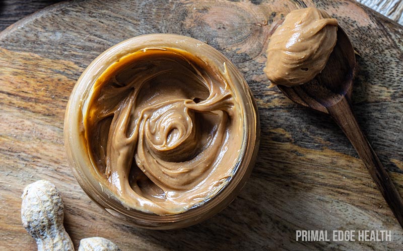 A serving of keto chocolate peanut butter cups on a wooden surface.