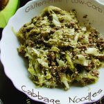 Cabbage noodles with ground beef in a white bowl.