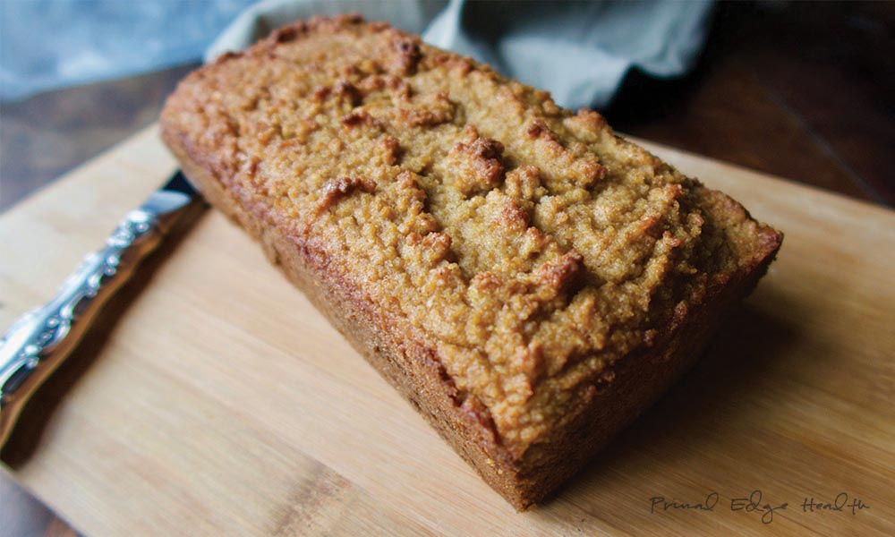 Ketogenic gingerbread on wooden cutting board with knife.