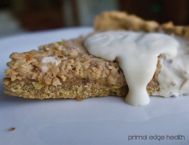 A slice of mince meat pie cream on a white surface.