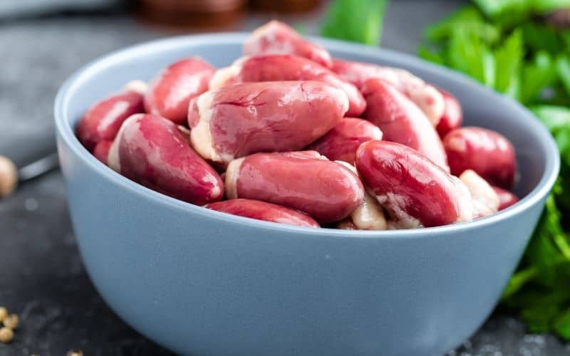 Raw meat in a light blue bowl.