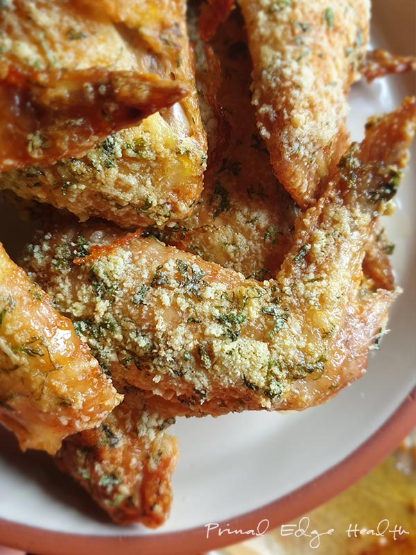 A delicious plate of keto chicken wings with herbs.
