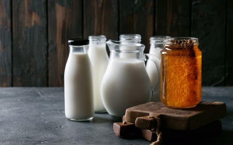 Jars of milk and a jar of honey.