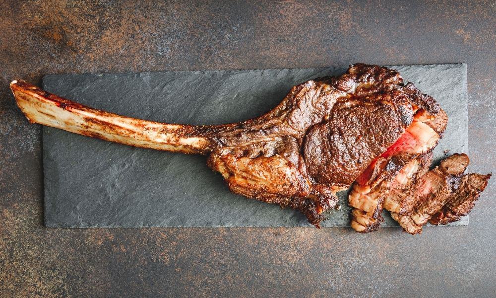 A piece of meat on a grey surface.