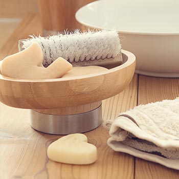 A wooden bowl with heart-shaped soap dish - perfect for cold process soap making with tallow.