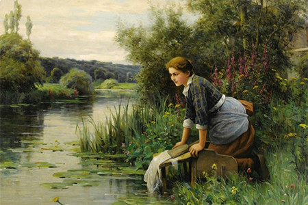 A woman in the river washing clothes.