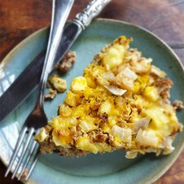 A keto-friendly quiche on a plate with a fork and knife.