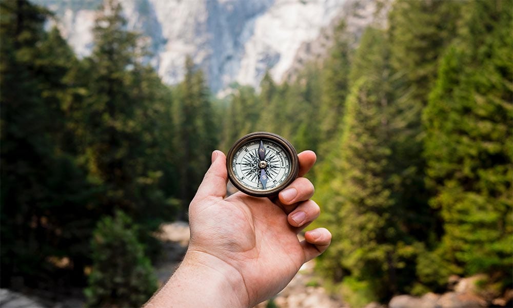 A person demonstrating ways to stick to a ketogenic diet in front of a forest.