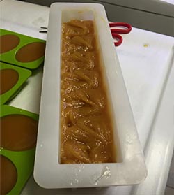 A tray of soap in mold sitting on a counter.