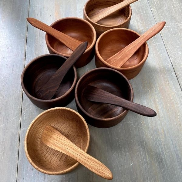 Several wooden bowls on a wooden surface.