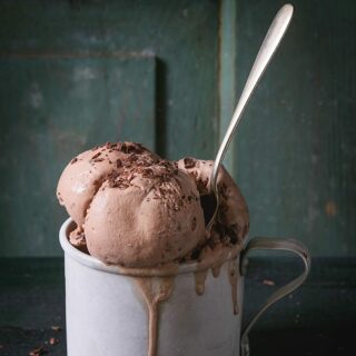 A cup of no churn keto ice cream with a spoon.