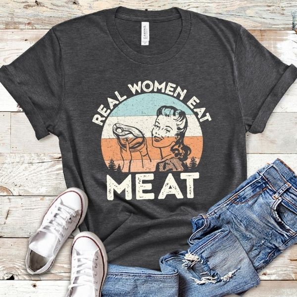A black shirt with "real woman eat meat" printed on it.