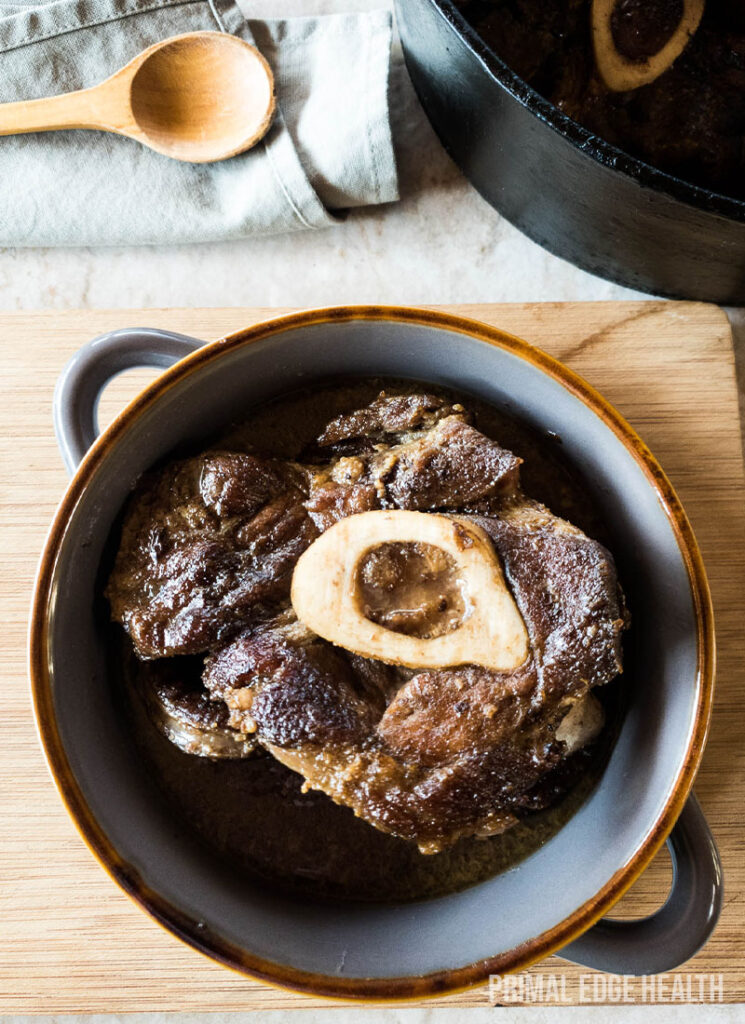 Cooked meat and marrow in blue ceramic bowl.