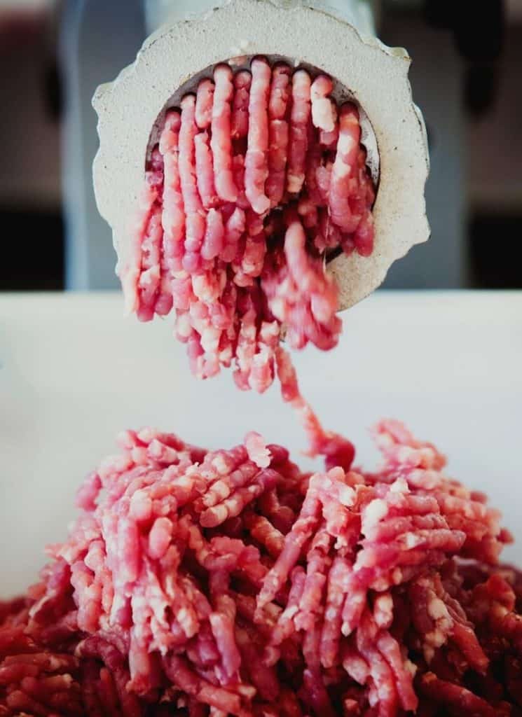 Ground beef on a white surface.