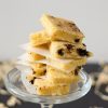 A stack of keto chocolate chip cookie bars on a glass plate.