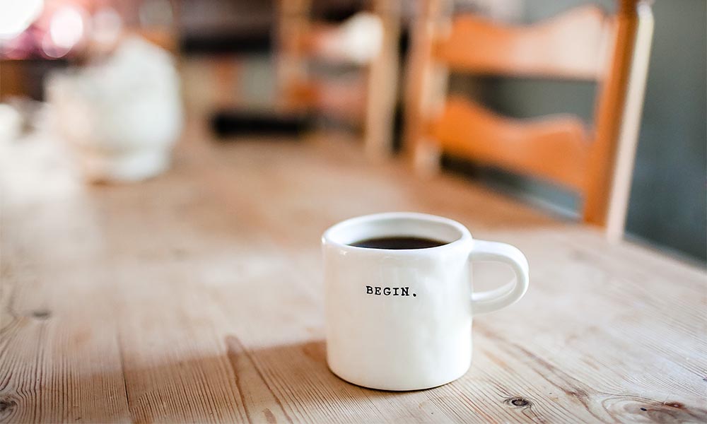 A cup of coffee on the wooden table.