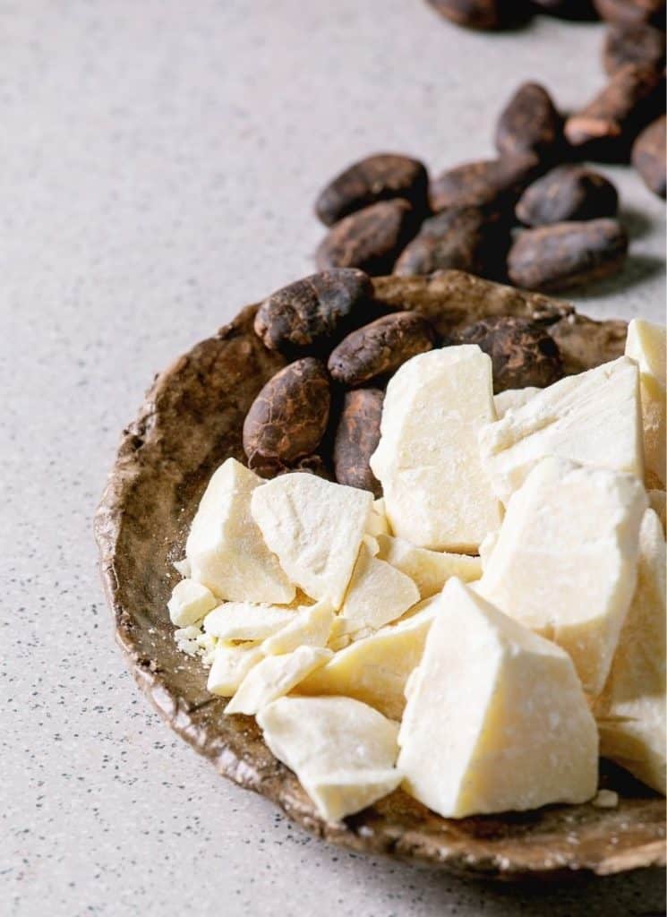 Cocoa butter keto in a brown bowl on a white surface.