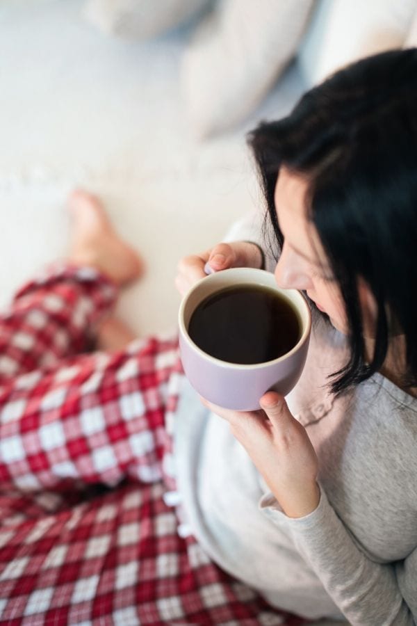 A woman about to drink coffee.