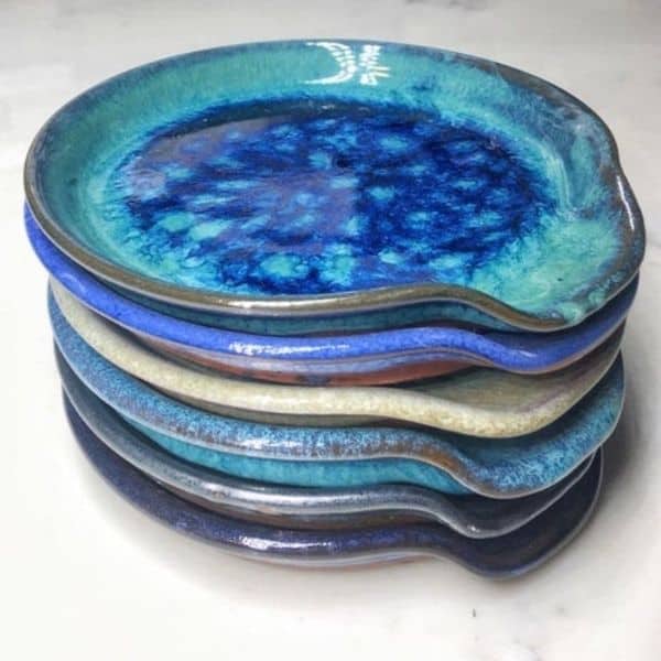 A stack of blue and white plates on a white surface.