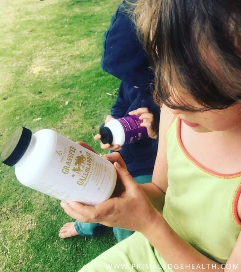 A child holding a white bottle.