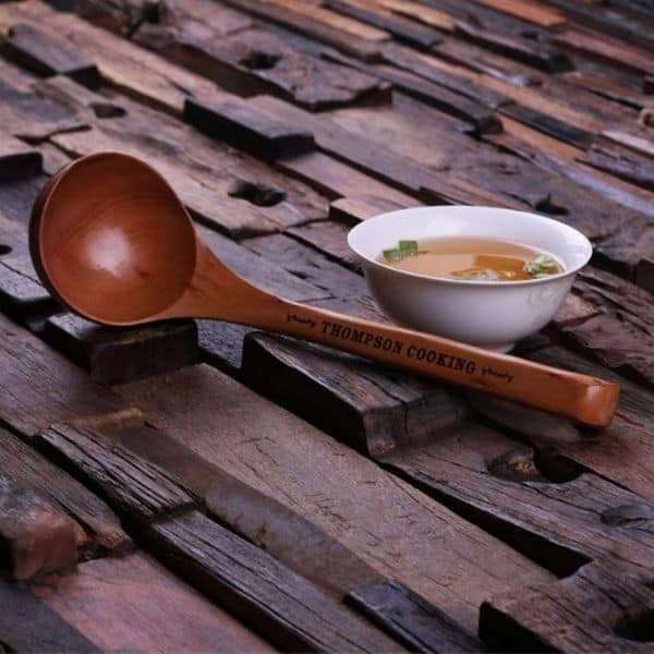 A keto beef stew served in a bowl with a wooden spoon.