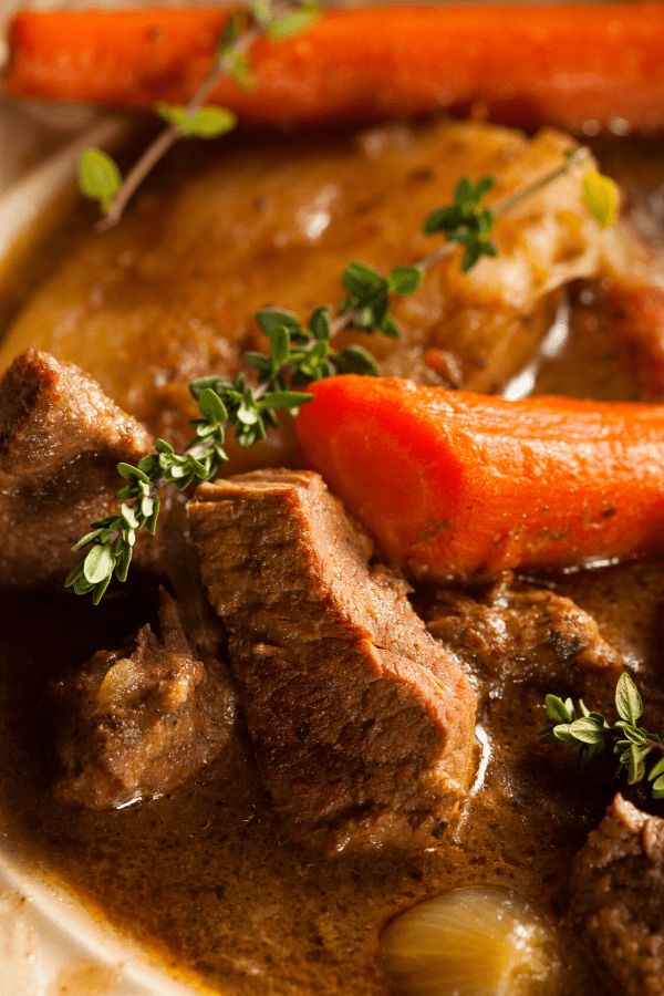 Keto beef stew with carrots and garnish.