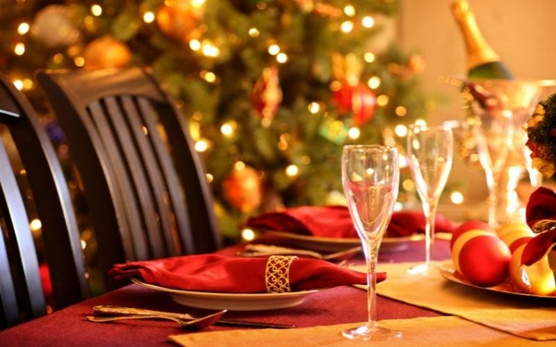 Elegant Christmas dinner table setting with champagne glasses.