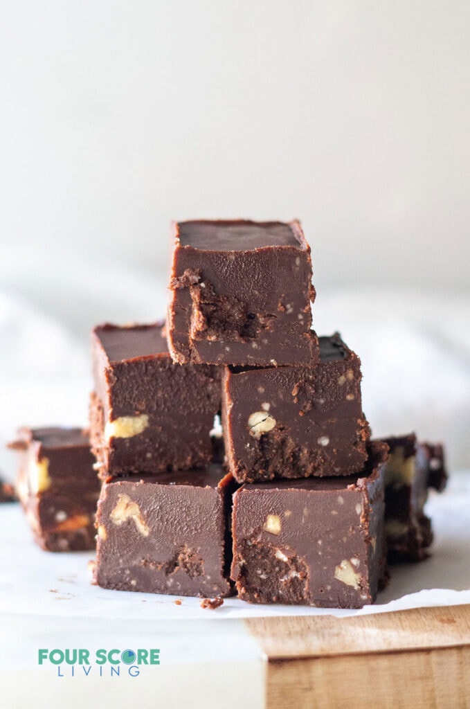 A stack of keto chocolate fudge on a cutting board.