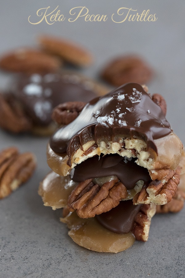 Keto pecan turtles on a grey background.