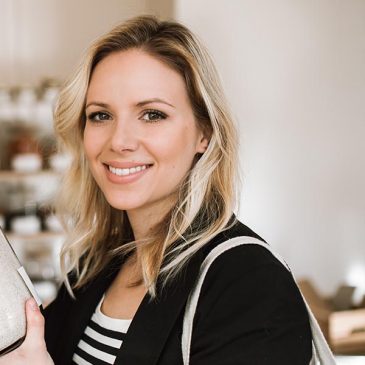 A picture of a blonde woman smiling.