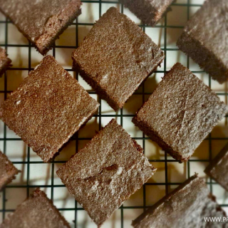 Flourless keto brownies in a cooling rack.