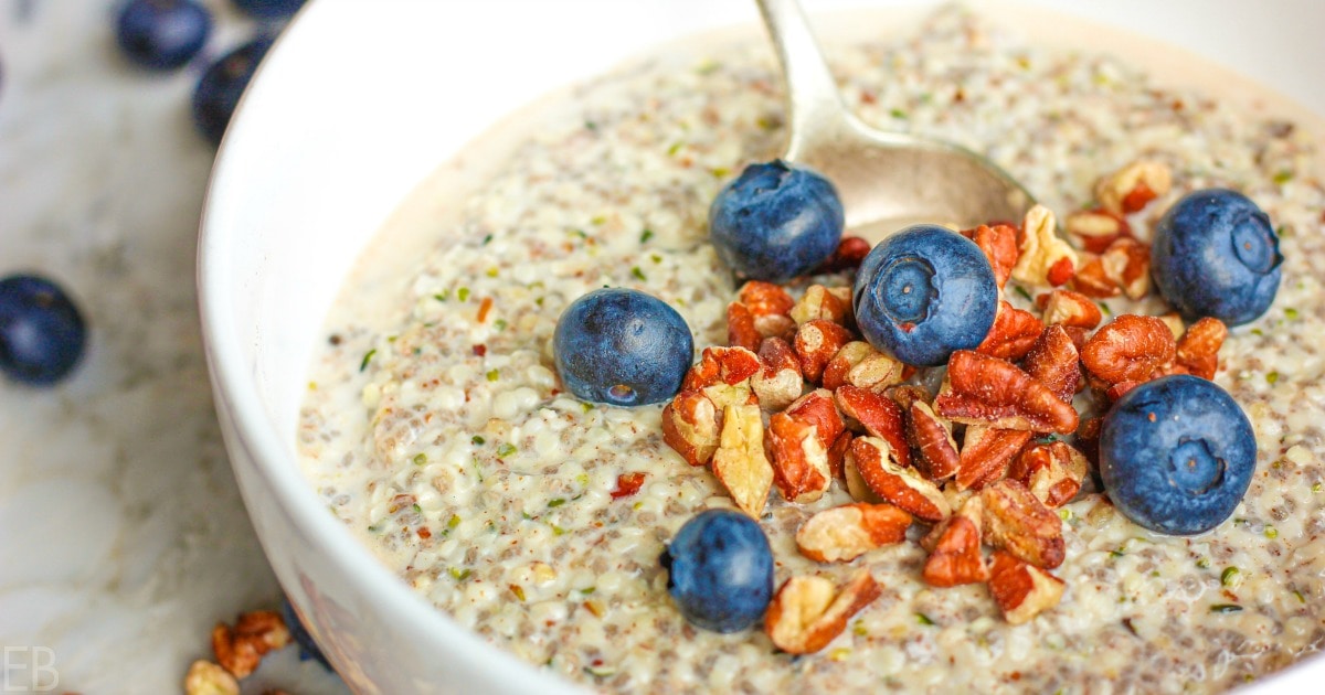 A bowl of oatmeal with a generous topping of blueberries and nuts.