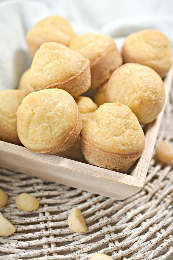 Keto macadamia nut muffins in a wooden basket.