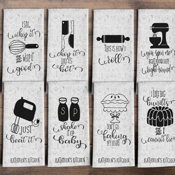 Various kitchen towels on a wooden surface.