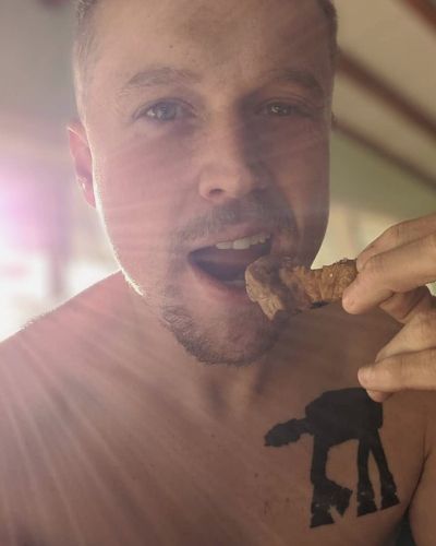 A man about to eat a piece of food.