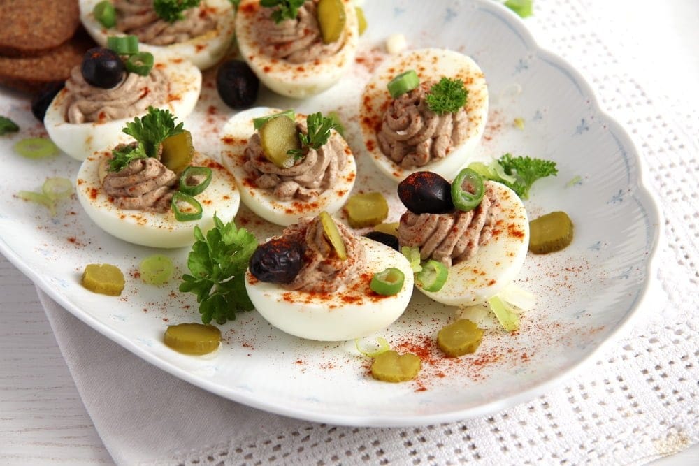 Deviled eggs in white plate.