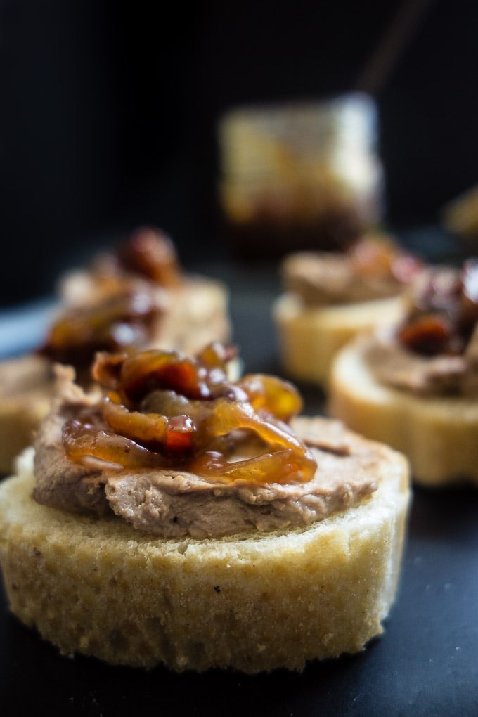 Low-carb chicken liver mousse with bacon jam on a dark surface.