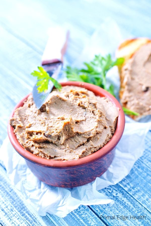 Beef liver pate in a bowl with a knife.