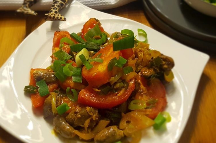 A simple chicken hearts recipe on a white plate.
