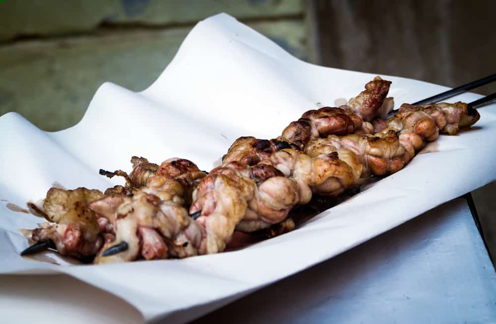 Grilled liver recipe on a white plate.