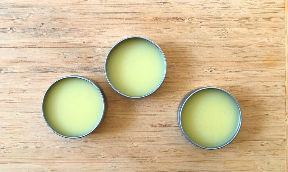 Three open tins of homemade beef tallow moisturizer.