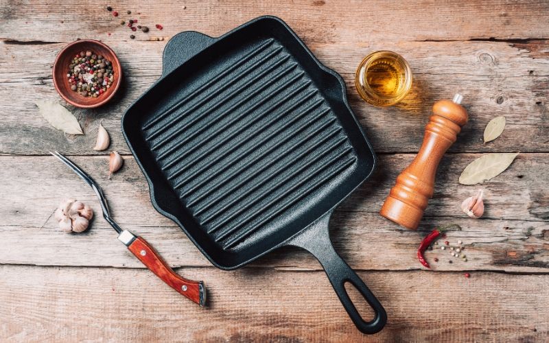 An empty pan on a wooden surface.