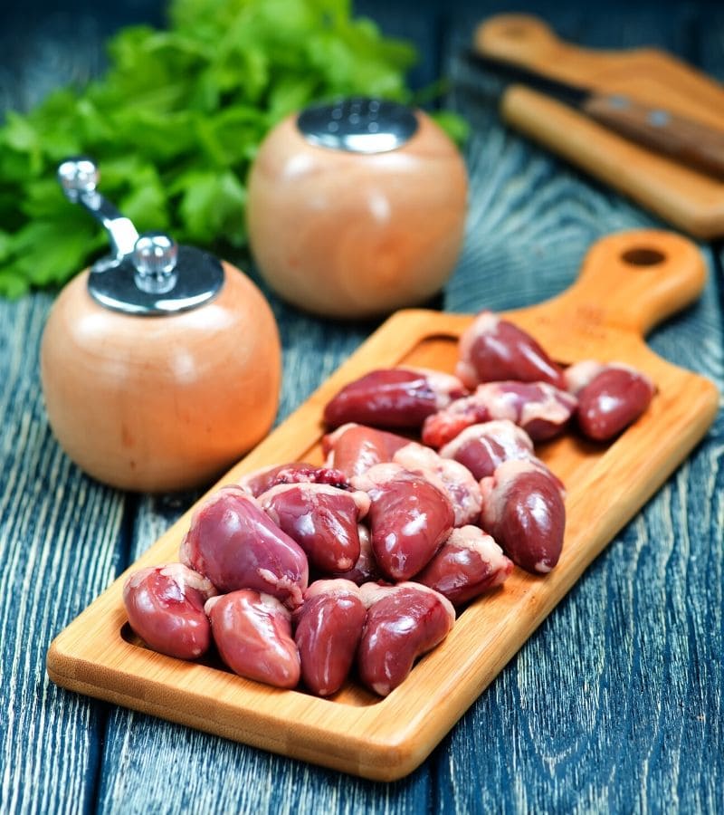 A serving of organ meat on a wooden surface.
