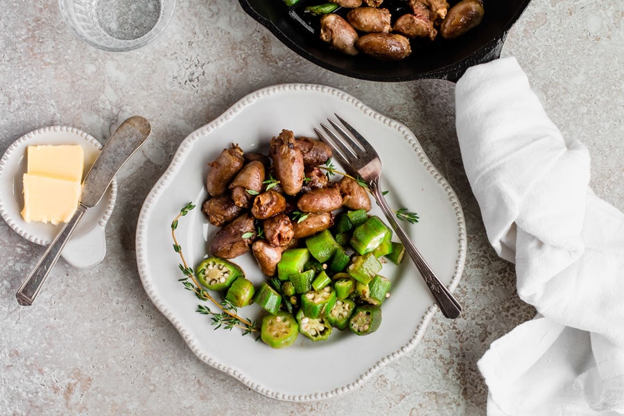 Sautéed chicken hearts recipe on a white plate.
