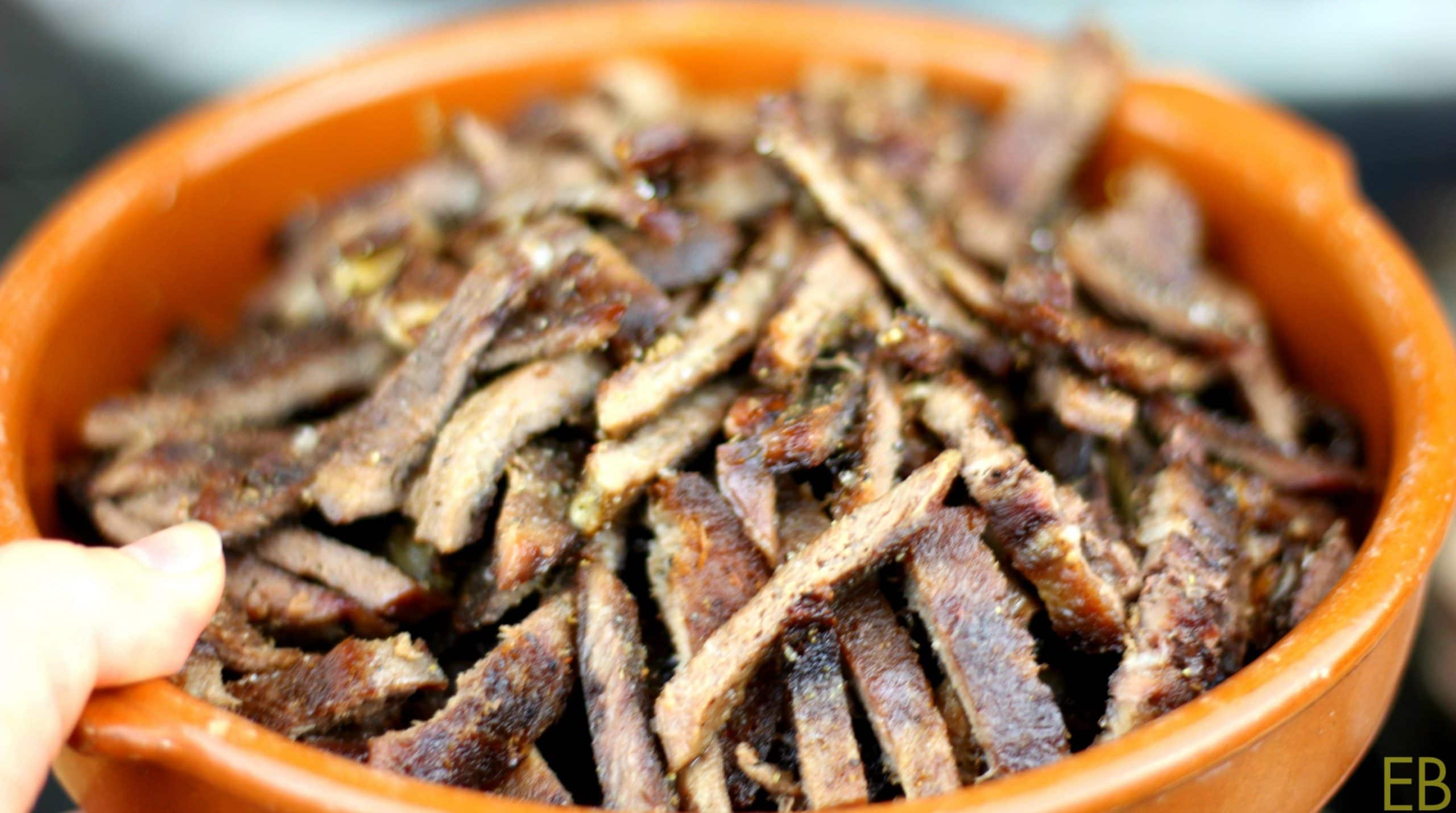 Beef tongue strips in an orange bowl.