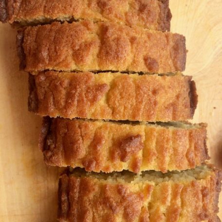 Slices of keto sandwich bread on a light wooden surface.