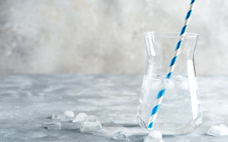 ice water in glass with straw