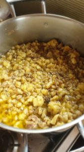 A pan full of rendered beef tallow on a stove top.