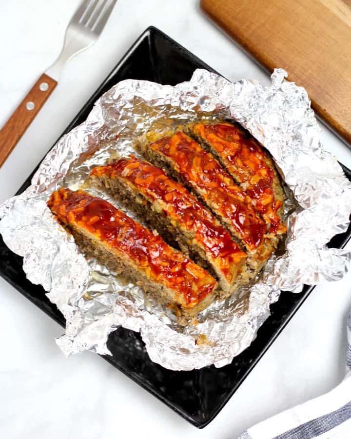 Instant pot keto meatloaf recipe on a black plate.