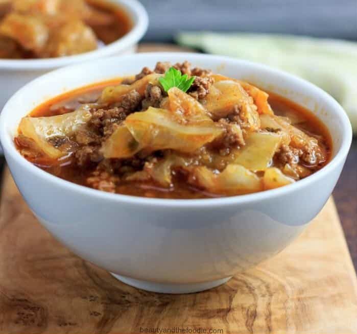 Keto instant-pot stuffed cabbage stew with ground beef in a white bowl.